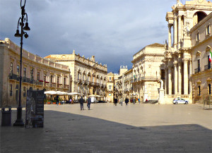 Sunlit main Piazza del Duomo of Palermo in Sicily with advertisement for an exhibition of Archimedes' work.