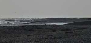 Coastal scene with shingle beach and breaking waves