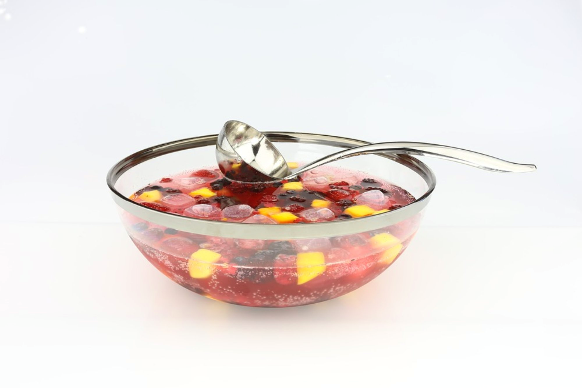 Bowl of punch with fruit and ice and with spoon
